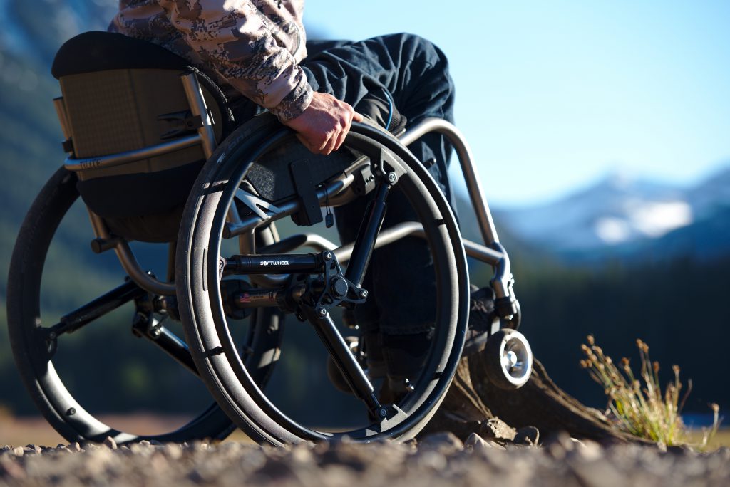 SoftWheeMan on wheelchair and SoftWheel wheels in the mountainsl wheel