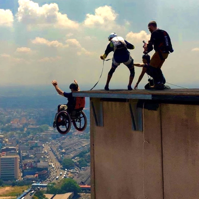 Man base jumping with wheelchair and SoftWheel wheels